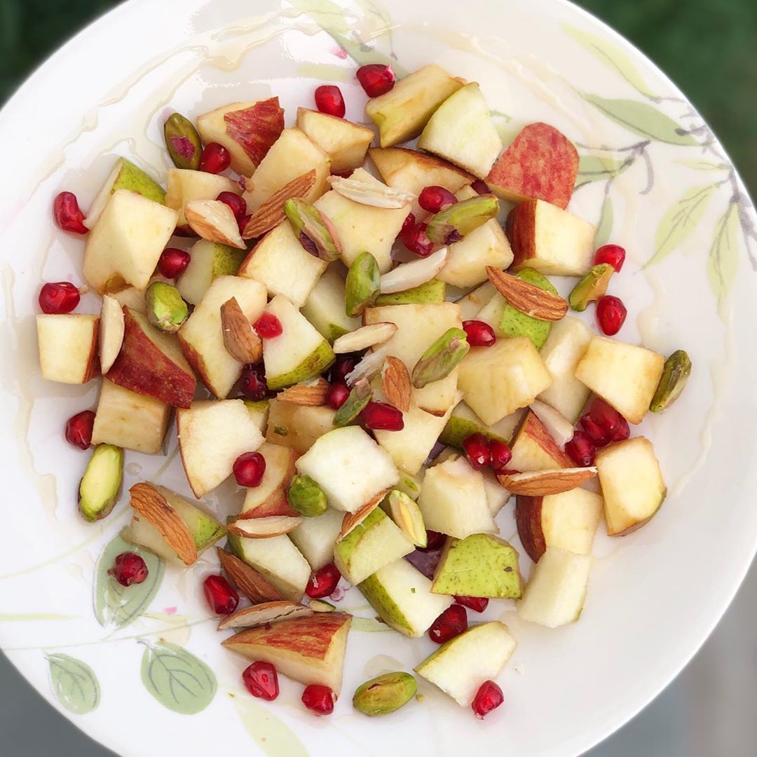 Deliciously healthy snack time on lazy Sunday day.
An antioxidant, vitamin and mineral rich plate to satisfy and support wellness. 
Fruits topped with nuts and glazed with honey 
#fruits #honey #nuts #pista #almond