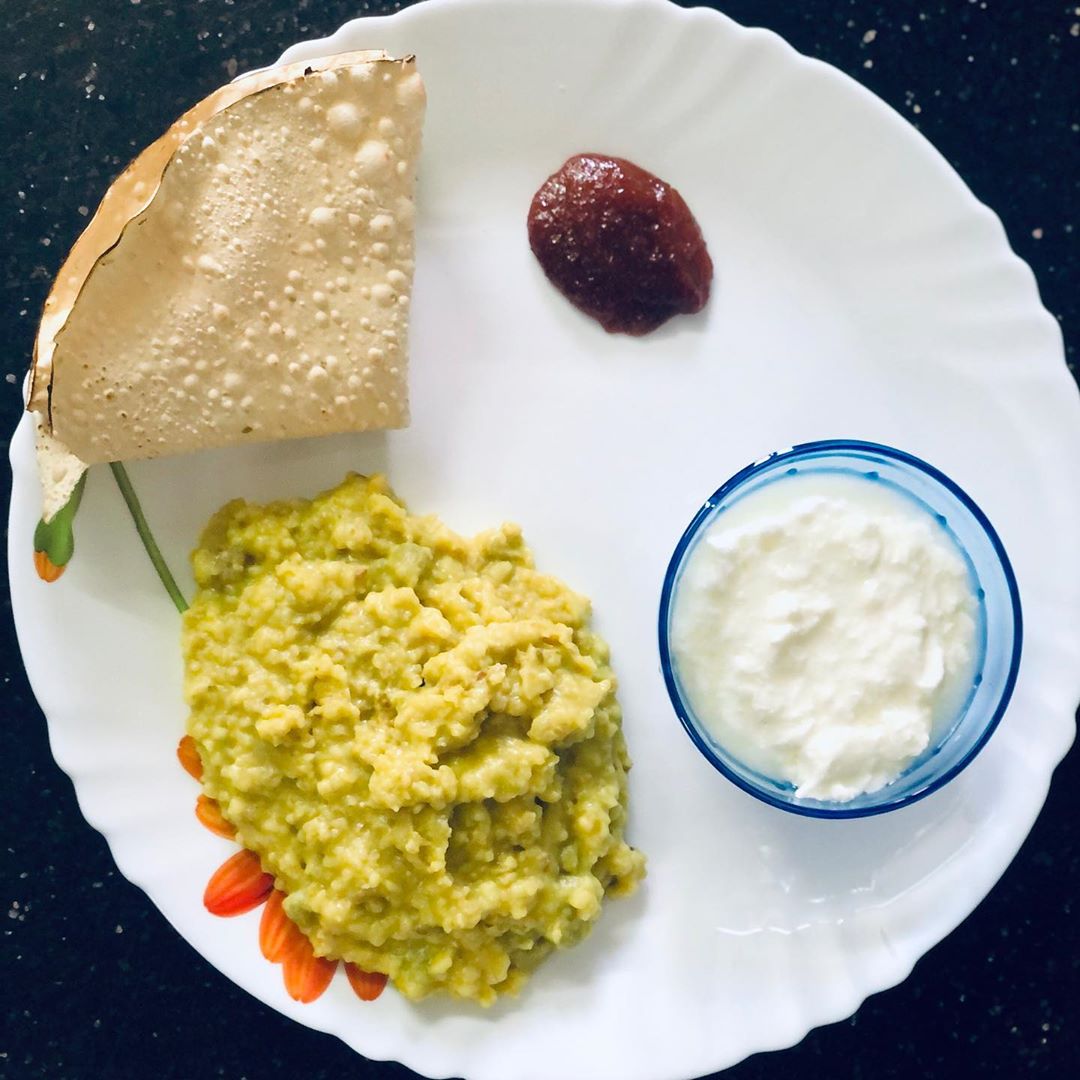 #kpmeals 
One of the most complete meal is said to be khichadi and that’s what today’s lunch is 
Daliya khichadi with proportion of 
Daliya and moong dal as 1:2 and some veggies like peas and onion ( as in this lockdown veggies are not available ) 
Daliya - complex carb 
Moong dal - protein 
Curd - protein 
Pickle - probiotic 
And papad that’s something I have it very rare. 
#daliyakhichadi #lunch #healthylunch #quarantinemeals